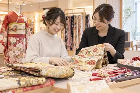振袖に合わせる帯と小物を選ぶスタッフとお客様（成人式・七五三の写真 No.18）