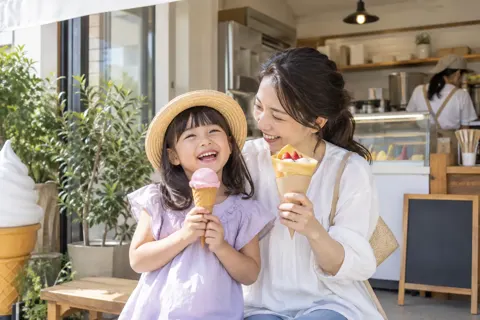 店先でアイスとクレープを持って笑う親子（アイス・クレープ・かき氷の写真 No.19）