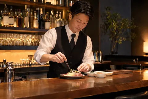 おつまみを小皿に盛るバーテンダー（バー・ショットバーの写真 No.42）