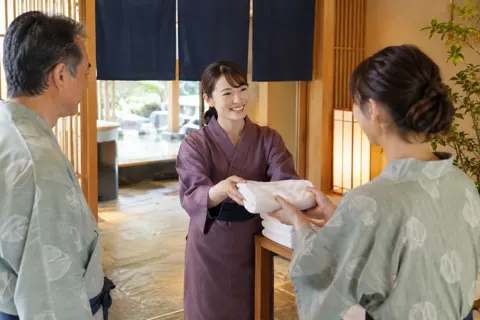 大浴場の入口でタオルを渡すスタッフ（ホテル・旅館の写真 No.41）