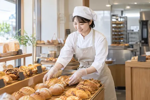 できたてを店にならべる店員（食品製造・販売の写真 No.64）