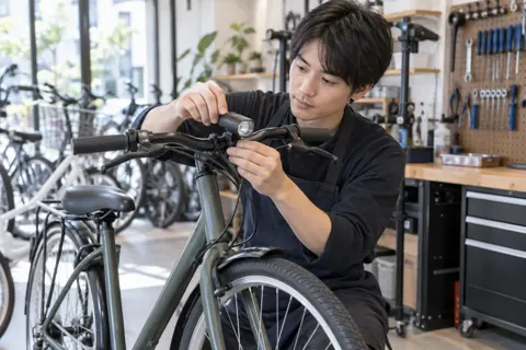 ライトを取り付ける店員（自転車販売・修理の写真 No.37）