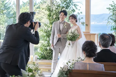 結婚式で新郎新婦を撮影するカメラマン（映像制作の写真 No.25）